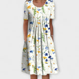 Emelie | Zomerjurk met wilde bloemenprint en plooien aan de voorkant