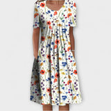 Emelie | Zomerjurk met wilde bloemenprint en plooien aan de voorkant