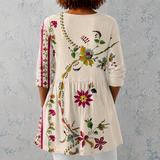 Clara | Lange blouse van linnen met folkloristisch bloemenpatroon en versierde zoom